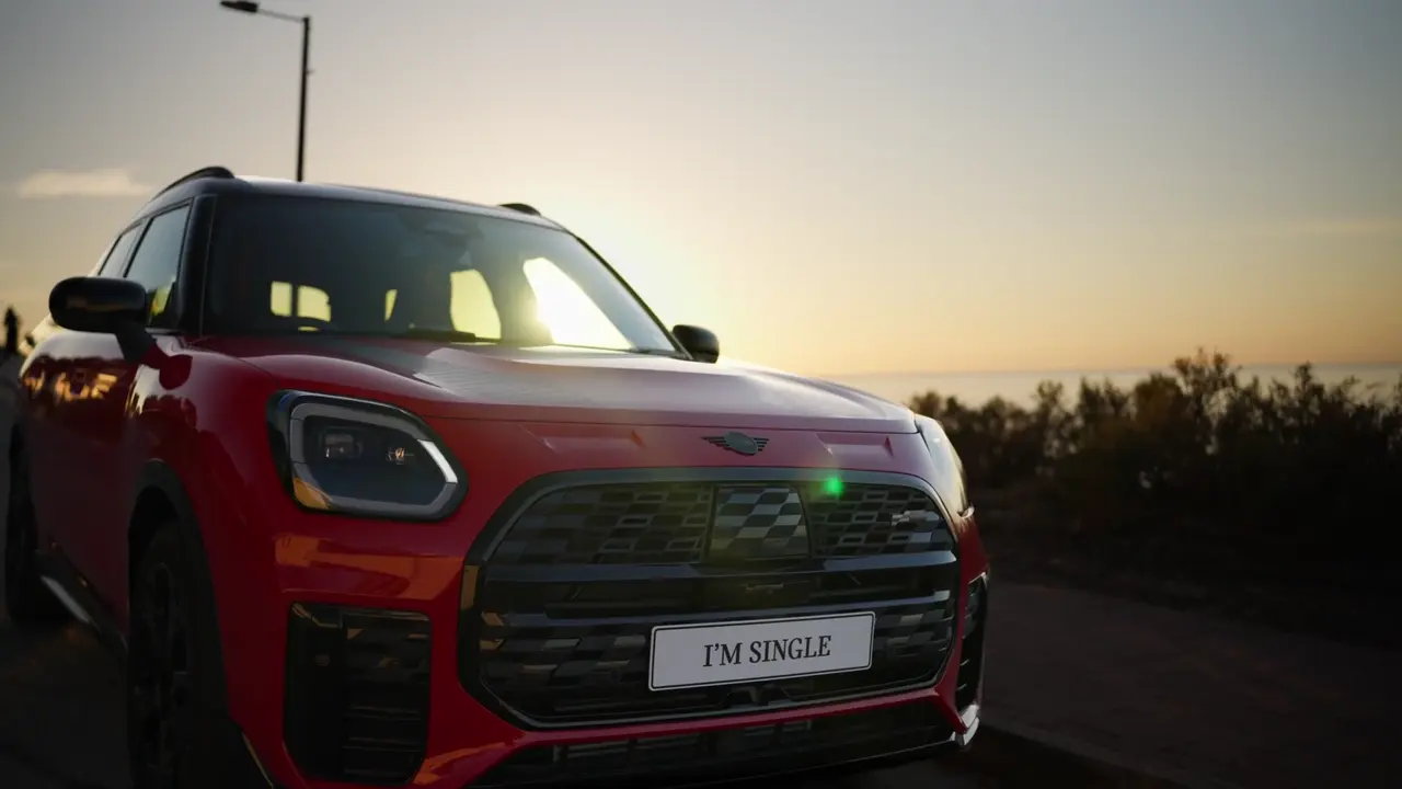 A red MINI Countryman on the coast at sunset, from a Glenelg Mini video