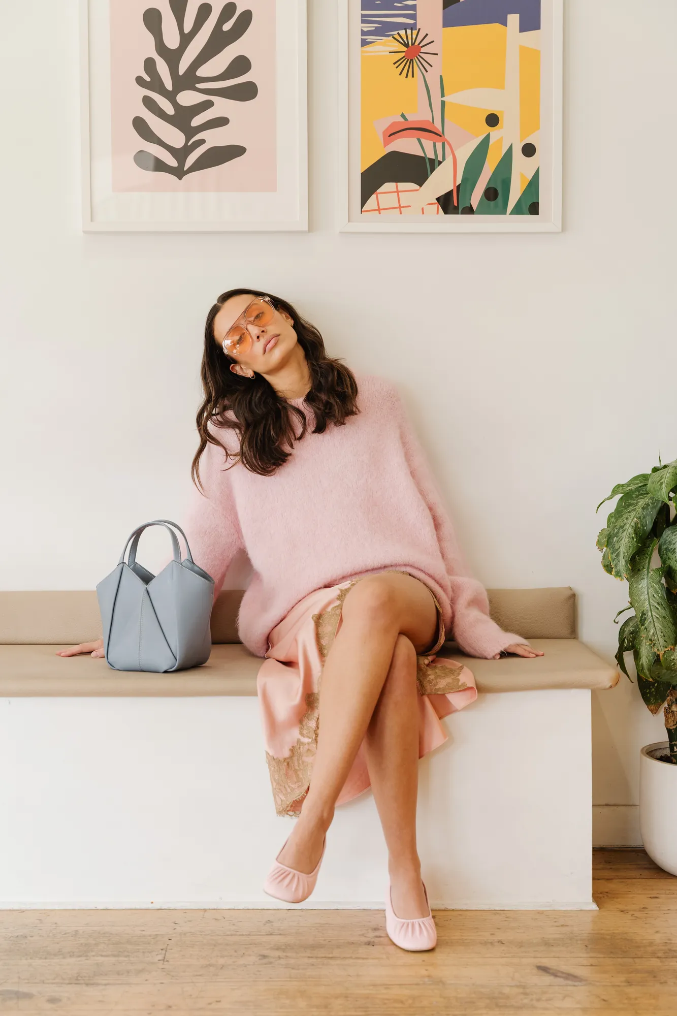 Penn Shoes campaign: pink knit and pink flats on a bench beneath framed prints
