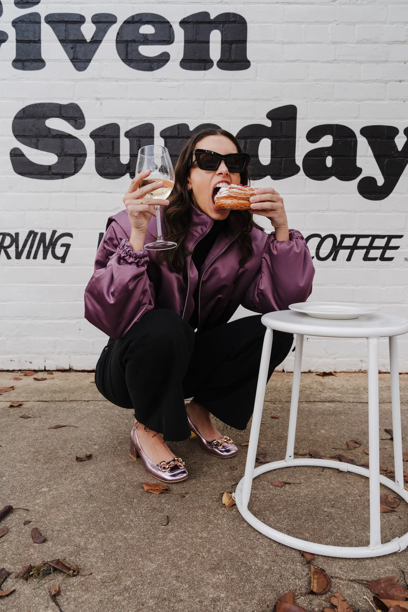 Penn Shoes campaign: purple bomber and patterned flats outside a painted brick wall